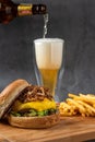 Cheeseburger with caramelized onions. french fries and beer Royalty Free Stock Photo