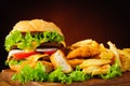 Cheeseburger, fried chicken nuggets and french fries Royalty Free Stock Photo