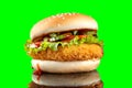 Cheeseburger hamburger isolated on green background. BBQ sauce and lettuce. Royalty Free Stock Photo