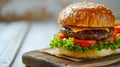 Cheeseburger with tomato and lettuce on white wooden table