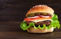 Cheeseburger on a wooden background. Hamburger with cheese. Burger isolated. Tasty Dinner.Copy space