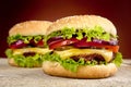 Cheeseburgers on wooden table on burned background Royalty Free Stock Photo