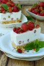 Cheesecake with berries, strawberries on shortbread dough. Delicious and simple cake on wooden background. Cheese pie. Homemade