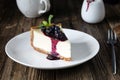 Cheesecake with black currant and blueberry sauce