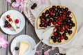 Cheesecake with cherry, two slices on saucers and metal tray on a wooden table. . Royalty Free Stock Photo