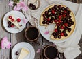 Cheesecake with cherry, two slices on saucers and metal tray on a wooden table. . Royalty Free Stock Photo