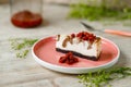 Cheesecake with chocolate flavor lies on a plate with wild strawberries on a wooden table. Royalty Free Stock Photo