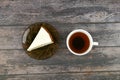 Cheesecake with coffee on a dark wooden background. view from above. A cheesecake next to it on a brown wooden background. retro Royalty Free Stock Photo