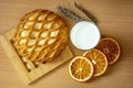 Cheesecake with cottage cheese, orange slices and a glass of milk on a wooden background. Still life with food. Bakery Royalty Free Stock Photo