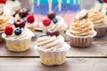Cheesecake cupcake with cream cheese frosting and fresh cherry on top, wooden background Royalty Free Stock Photo