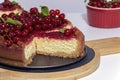 Cheesecake with red currant and mint on wooden board. Top view