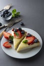 Cheesecake with fresh berries and mint for dessert - healthy organic summer dessert pie cheesecake. Cheese cake. Gray background Royalty Free Stock Photo