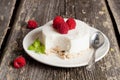 Cheesecake with fresh raspberries and mint leaves on top on a wo Royalty Free Stock Photo