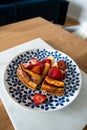 Cheesecake with fresh strawberries and strawberry sauce on a colorful plate. Delicious dessert. Royalty Free Stock Photo