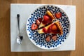 Cheesecake with fresh strawberries and strawberry sauce on a colorful plate. Delicious dessert. Royalty Free Stock Photo