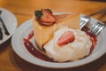 Cheesecake with fresh strawberry and whipped cream decoration with strawberry sauce Royalty Free Stock Photo