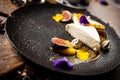 Cheesecake with passionfruit, fig and orange on a plate. Delicious healthy food closeup served for lunch on a table in Royalty Free Stock Photo