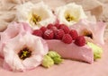 Cheesecake with raspberries and fresh flowers on a plate