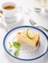 Cheesecake with ricotta cheese on a beautiful plate, vintage fork, a cup of aromatic espresso and water with lemon. Royalty Free Stock Photo