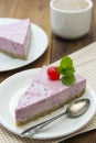 Cheesecake slice with berries and coffee cup, pink cheesecake on wooden background, dessert or breakfast. Sweet food