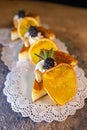 Cheesecake Slices with Orange Slices and Blackberries