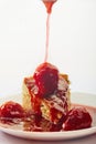 Cheesecake with strawberry jam on a white plate on a light background Royalty Free Stock Photo