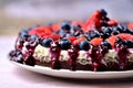 Cheesecake tart with fresh strawberries, blueberries and cherry jam. Royalty Free Stock Photo