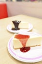 Cheesecake under strawberry sauce on white cutting board Royalty Free Stock Photo