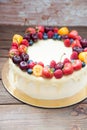 Cheesecake with white chocolate, fresh berries, strawberries, cherries, blueberries and raspberries on wooden background Royalty Free Stock Photo