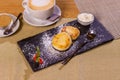 Cheesecakes with strawberries. Two fried curds on a black tray. Close-up. Royalty Free Stock Photo