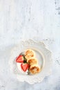 Cheesecakes on a white plate with strawberries. Dish for Breakfast. Copy of the space