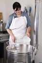Cheesemaker pours rennet Royalty Free Stock Photo