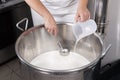 Cheesemaker pours rennet Royalty Free Stock Photo
