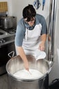 Cheesemaker pours rennet Royalty Free Stock Photo