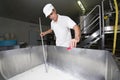 Cheesemaker pours rennet Royalty Free Stock Photo