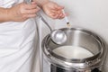 Cheesemaker pours the rennet with a syringe Royalty Free Stock Photo