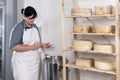 Cheesemaker pours the rennet with a syringe Royalty Free Stock Photo