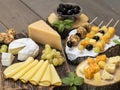 Cheeses of different varieties on a wooden background. Royalty Free Stock Photo