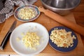 Cheeses pieces for the preparation of a traditional savory pie, with a rolling pin, a knife, and a pan Royalty Free Stock Photo
