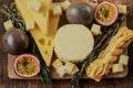 cheeses, rosemary and passion fruit.milk fat and Milk products.Cheese platter with fruits. Cheese board set. assorted Royalty Free Stock Photo