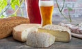 Cheeses and Tomme de Savoie with beer, French cheese Savoy, french Alps France Royalty Free Stock Photo