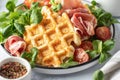 Cheesy belgian waffles served with ham, tomatoes and lettuce corn on white marble background close up. Savory waffles