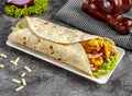 Cheesy Chicken shawarma Wrap served in a cutting board on grey background side view of fastfood Royalty Free Stock Photo