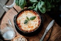 Cheesy italian lasagna with basil garnish on rustic table setting Royalty Free Stock Photo