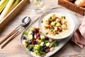 cheesy leek soup with croutons, bacon and fresh lettuce leaves on a wooden table Royalty Free Stock Photo