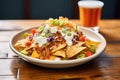 cheesy nachos with a scoop of sour cream on top