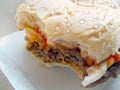 Cheesy Onion Burger, A Tasty Beef Patty with Melted Cheese, Onions, and Tangy Tomato Sauce on a Soft Bun Royalty Free Stock Photo