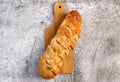Cheesy Stuffed Garlic French Bread on a small cutting wooden board on a dark grey background