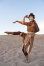 Cheetah woman dances in desert