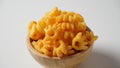 Cheetos is a crunchy corn puff snack. Bright orange cheese puffs in a wooden bowl Royalty Free Stock Photo